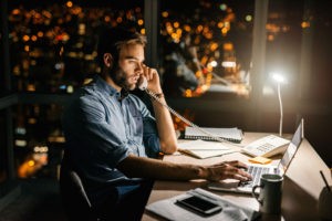 Man at desk working overtime