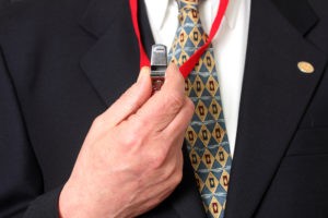 Man in suit holding a whistle